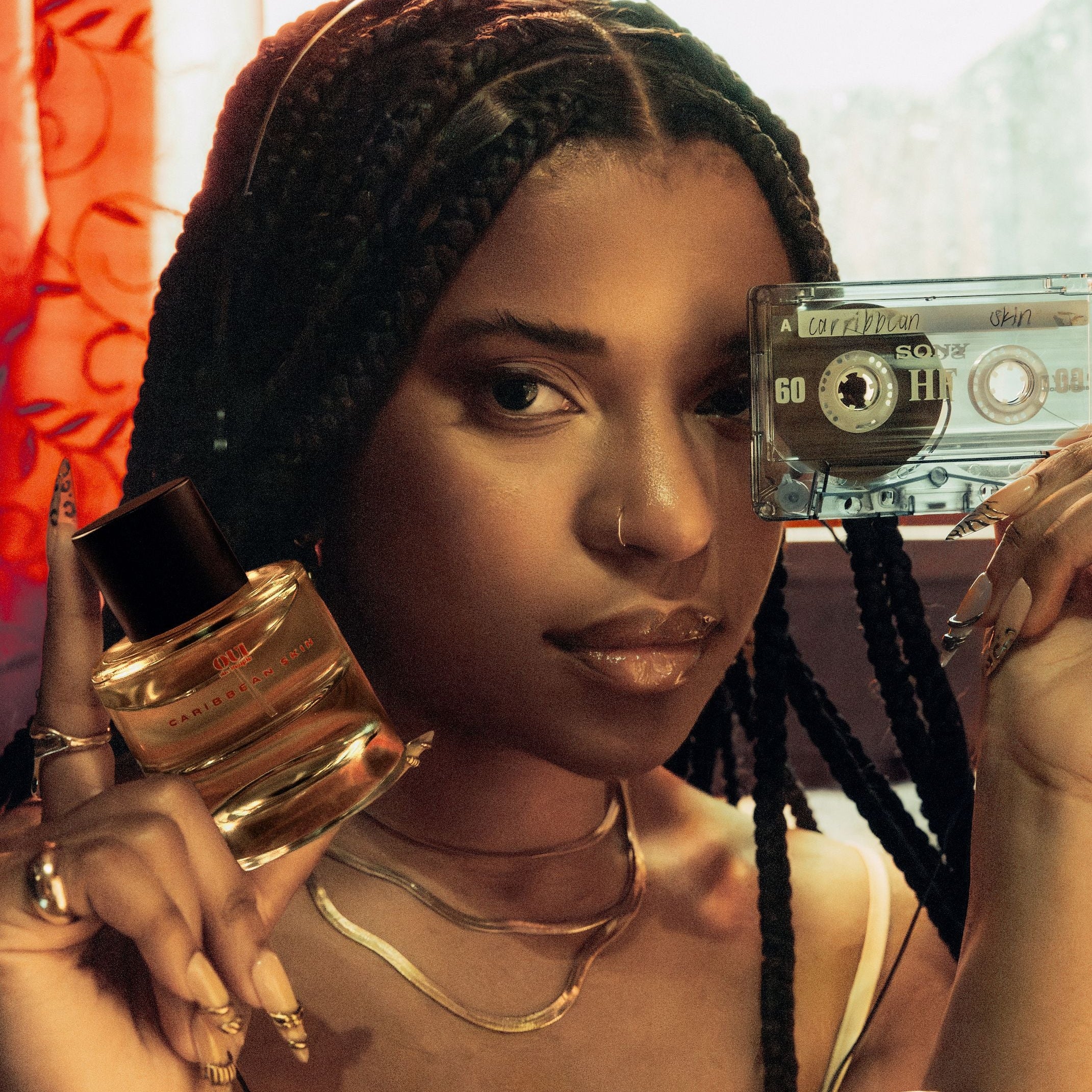 Women holding cassette tape and clear bottle with black lid