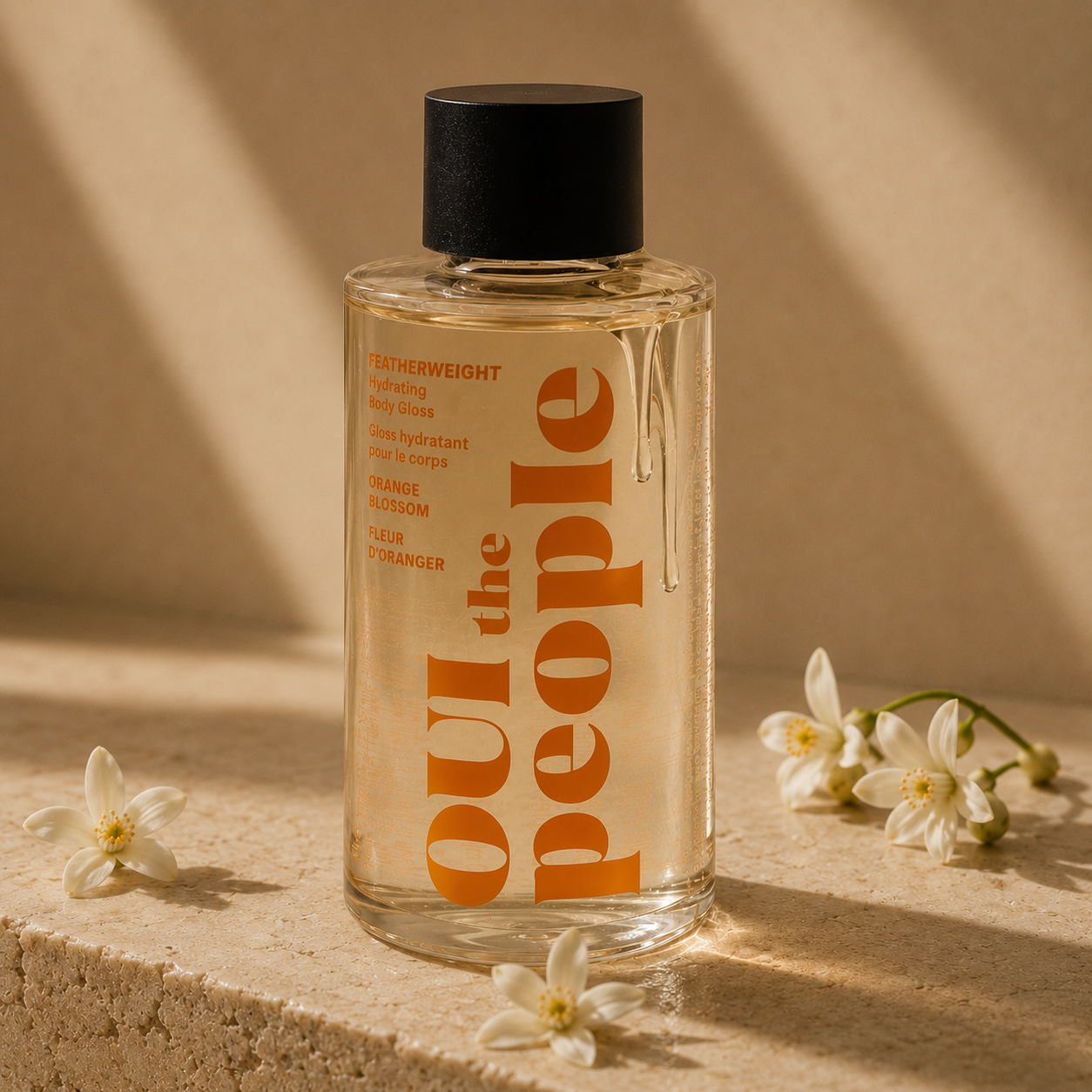Featherweight Hydrating Body Gloss bottle with orange blossom flowers